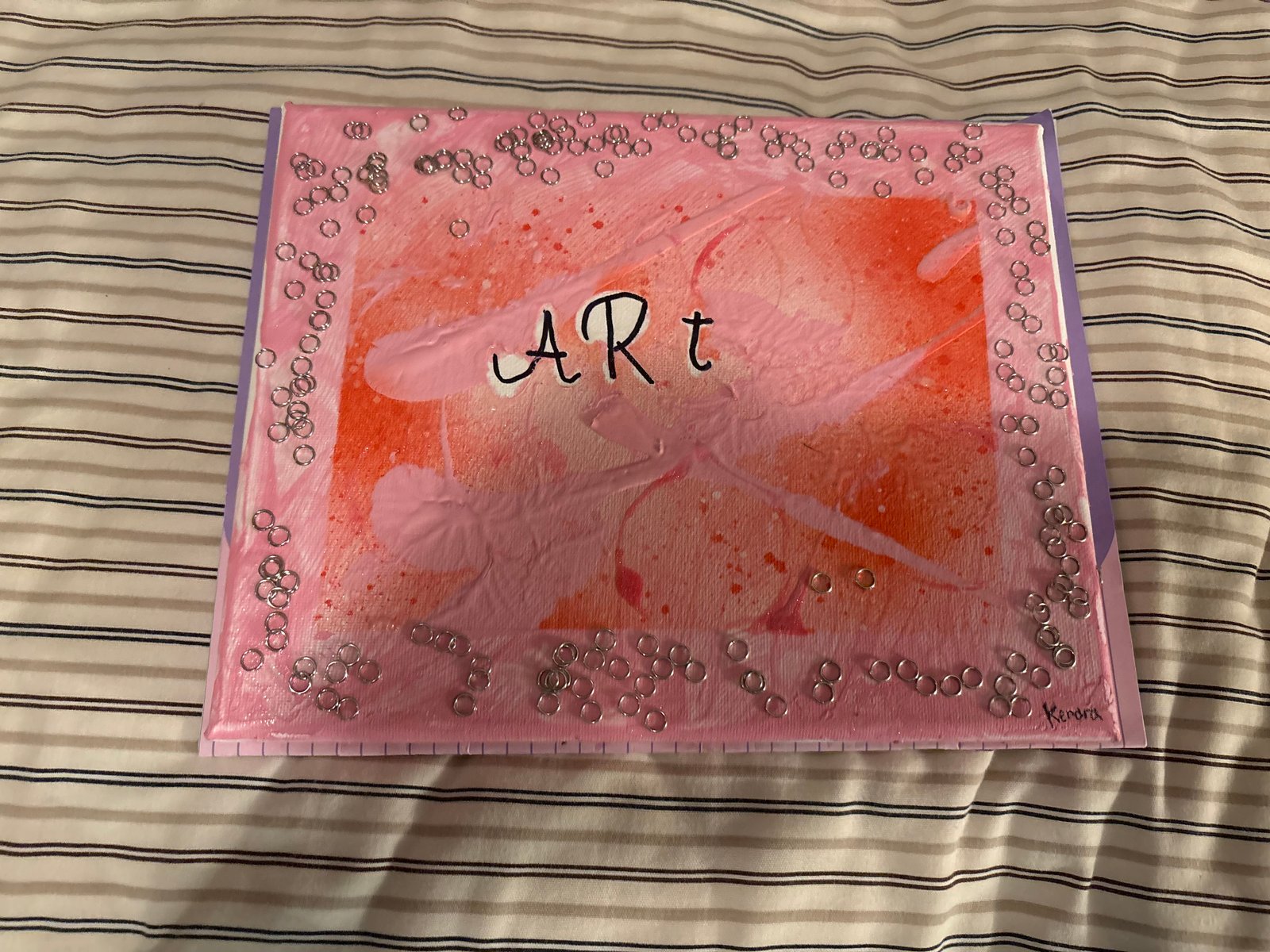 Original mixed-media canvas titled ART by young artist Kendra — pink and orange abstract with silver ring accents